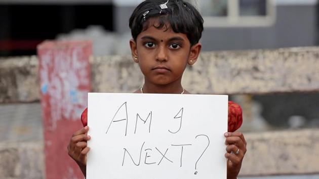 A girl holds a placard during a protest against the Kathua rape case in Kochi on April 15, 2018. On April 13, Prime Minister Narendra Modi decided that the two Jammu and Kashmir ministers -- Lal Singh and Chander Prakash Ganga, who participated in a rally defending the Kathua rape accused had to go, said two leaders familiar with political developments that led up to their resignation. (Sivaram V / REUTERS) 
