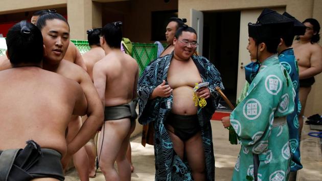 Sumo wrestlers and referees wait for the start of the annual sumo tournament. Earlier this month, Japan Sumo Association chairman Hakkaku, who led a prayer during a more reflective moment in the shrine, was forced to apologise after a referee expelled several female medics, when they attempted to revive local mayor Ryozo Tatami, who had collapsed during a tournament near Kyoto. (Toru Hanai / REUTERS) Sumo wrestlers and referees wait for the start of the annual sumo tournament. Earlier this month, Japan Sumo Association chairman Hakkaku, who led a prayer during a more reflective moment in the shrine, was forced to apologise after a referee expelled several female medics, when they attempted to revive local mayor Ryozo Tatami, who had collapsed during a tournament near Kyoto. (Toru Hanai / REUTERS)