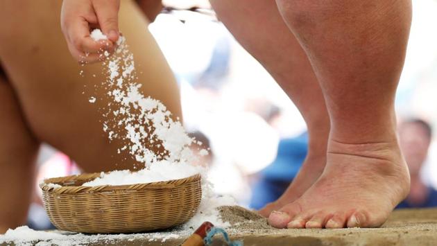 A wrestler grabs salt before competing during the tournament. As the ancient sport looks to move on from a raft of negative publicity surrounding incidents ranging from assault and bullying to accusations of sexism, there were few signs evident that recent issues would dampen sumo’s popularity. (Toru Hanai / REUTERS) A wrestler grabs salt before competing during the tournament. As the ancient sport looks to move on from a raft of negative publicity surrounding incidents ranging from assault and bullying to accusations of sexism, there were few signs evident that recent issues would dampen sumo’s popularity. (Toru Hanai / REUTERS)
