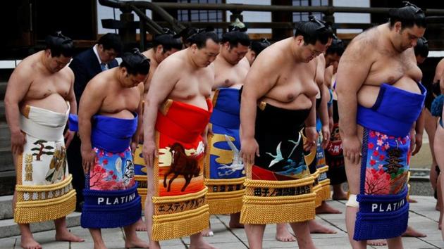 Sumo wrestlers pray at the Yasukuni shrine. Fans, fresh from seeing their heroes up close in the Tokyo sunshine, hoped that this particular ceremony leads to a scandal-free year as sumo looks to rebuild a tarnished reputation. (Toru Hanai / REUTERS) Sumo wrestlers pray at the Yasukuni shrine. Fans, fresh from seeing their heroes up close in the Tokyo sunshine, hoped that this particular ceremony leads to a scandal-free year as sumo looks to rebuild a tarnished reputation. (Toru Hanai / REUTERS)