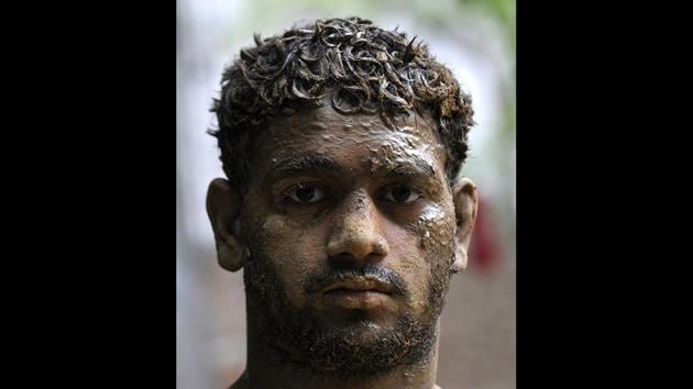 A young wrestler caked with soil post a training session. A regular diet for any wrestler includes huge quantities of almonds, 1.5 litres milk, fruits, juice and other protein nutrients running up to Rs. 1000 a day. Although the wrestlers here train for free, the cost of such diets piles up, making it difficult for even a few to take up wrestling professionally. (Sunil Ghosh / HT Photo) A young wrestler caked with soil post a training session. A regular diet for any wrestler includes huge quantities of almonds, 1.5 litres milk, fruits, juice and other protein nutrients running up to Rs. 1000 a day. Although the wrestlers here train for free, the cost of such diets piles up, making it difficult for even a few to take up wrestling professionally. (Sunil Ghosh / HT Photo)