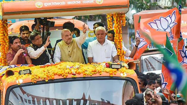 BJP President Amit Shah with Karnataka BJP chief BS Yeddyurappa and party leader Jagadish Shettar during a road show in Hubli on April 12, 2018. (PTI) BJP President Amit Shah with Karnataka BJP chief BS Yeddyurappa and party leader Jagadish Shettar during a road show in Hubli on April 12, 2018. (PTI)