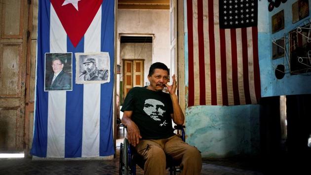 Armando Ricart Batista, a teacher by training, a former boxer and actor, poses next to Cuban and US flags at his home. Ricart, 65, while not affiliated with the Communist Party hopes the new leaders will follow the ideals of the Castros. He said he hangs the US flag because relations improved under Barack Obama, and the majority of Americans are in favor of relations with Cuba. (Ramon Espinosa / AP) Armando Ricart Batista, a teacher by training, a former boxer and actor, poses next to Cuban and US flags at his home. Ricart, 65, while not affiliated with the Communist Party hopes the new leaders will follow the ideals of the Castros. He said he hangs the US flag because relations improved under Barack Obama, and the majority of Americans are in favor of relations with Cuba. (Ramon Espinosa / AP)