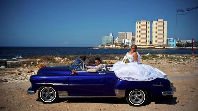 Nnewly-weds Dariel Verdecia, a 24-year-old computer engineer, and Roxana Cruz, a 26-year-old chemical engineer, pose for wedding portraits in a vintage American car. The couple said President Raul Castro’s stepping down will be another step forward in Cuba’s history, giving an entrance to new generations, and have hope the economy will continue growing. (Ramon Espinosa / AP) Nnewly-weds Dariel Verdecia, a 24-year-old computer engineer, and Roxana Cruz, a 26-year-old chemical engineer, pose for wedding portraits in a vintage American car. The couple said President Raul Castro’s stepping down will be another step forward in Cuba’s history, giving an entrance to new generations, and have hope the economy will continue growing. (Ramon Espinosa / AP)