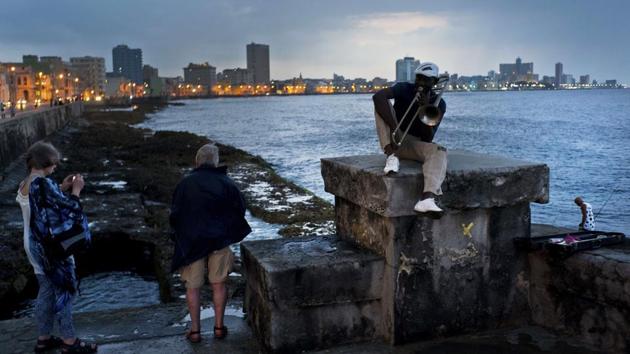 Musician Lazaro Martinez poses with his trombone on the Malecon sea wall in Havana, Cuba. Since 1991, Martinez has regularly played his music at the Malecon. “My politics are music,” the 52-year-old said. (Ramon Espinosa / AP) Musician Lazaro Martinez poses with his trombone on the Malecon sea wall in Havana, Cuba. Since 1991, Martinez has regularly played his music at the Malecon. “My politics are music,” the 52-year-old said. (Ramon Espinosa / AP)