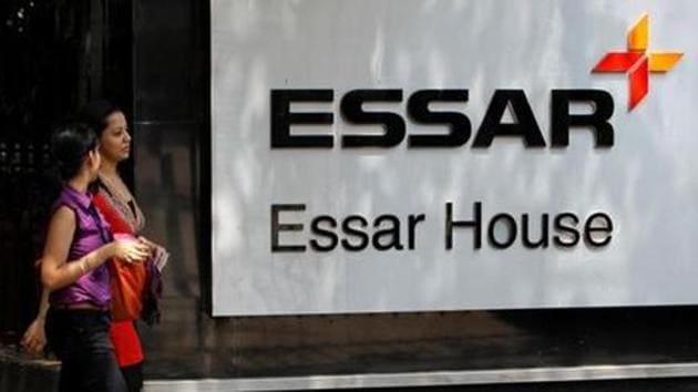 Employees walk past the Essar Group logo headquarters in Mumbai.(Reuters File)