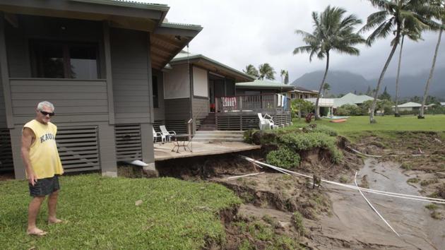 Richard Morris looks at the flood damage to his sister's home on Monday, April 16, 2018, in Hanalei, Kauai. (AP) Richard Morris looks at the flood damage to his sister's home on Monday, April 16, 2018, in Hanalei, Kauai. (AP)