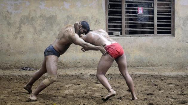 Over 100 amateur and professional wrestlers, including schoolchildren, train on a daily basis at Sukhbir Pahalwan’s akhara here in Sarfabad. Scratching a bit deeper one can find as many as 200-250 amateurs and professionals in this Noida village. Predominantly home to the Yadav community, families’ boast of their in-house wrestlers’ ‘khurak’ (diet) and matchmaking is done according to the men’s chest size. (Sunil Ghosh / HT Photo) Over 100 amateur and professional wrestlers, including schoolchildren, train on a daily basis at Sukhbir Pahalwan’s akhara here in Sarfabad. Scratching a bit deeper one can find as many as 200-250 amateurs and professionals in this Noida village. Predominantly home to the Yadav community, families’ boast of their in-house wrestlers’ ‘khurak’ (diet) and matchmaking is done according to the men’s chest size. (Sunil Ghosh / HT Photo)