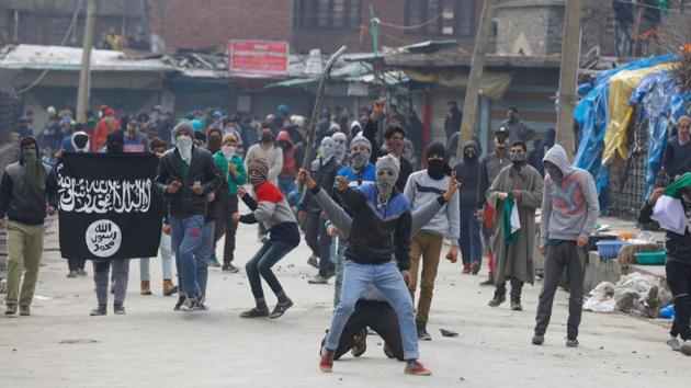 Kashmiri protesters wave an ISIS flag and throw stones towards security forces during clashes in Srinagar on February 17, 2017.(AFP File Photo)