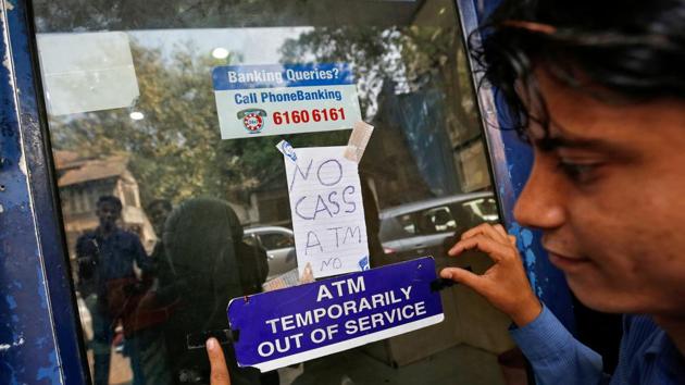 A security guard puts a notice outside an ATM in Mumbai, India. (REUTERS FILE PHOTO) A security guard puts a notice outside an ATM in Mumbai, India. (REUTERS FILE PHOTO)