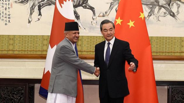 Nepalese foreign minister Pradeep Kumar Gyawali (left) shakes hands with Chinese foreign minster Wang Yi at the Diaoyutai State Guesthouse in Beijing on April 18, 2018.(Reuters)