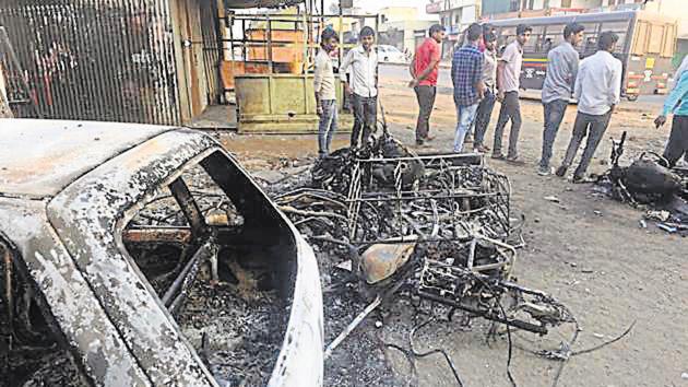 Torched vehicles at Bhima Koregaon violence in Pune.(HT FILE PHOTO)