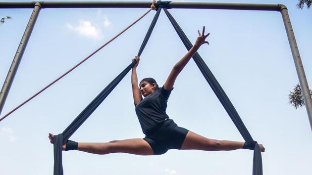 A girl hones her aerial yoga skills during a summer holiday camp at Modern English Medium High School in Shivajinagar on Wednesday. (SANKET WANKHADE/HT PHOTO) A girl hones her aerial yoga skills during a summer holiday camp at Modern English Medium High School in Shivajinagar on Wednesday. (SANKET WANKHADE/HT PHOTO)
