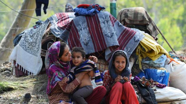 A family sits outside their camp while migrating out of Jammu. The Bakarwals say that the local governments harass them by evicting them from land and putting barbed wire around forests that they have used for camps. (Sajjad Hussain / AFP) A family sits outside their camp while migrating out of Jammu. The Bakarwals say that the local governments harass them by evicting them from land and putting barbed wire around forests that they have used for camps. (Sajjad Hussain / AFP)