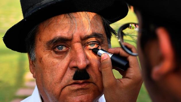 Talin Mavani helps apply make-up for his grandfather Ashok Aswani during the event commemorating the actor’s 129th birthday. Earlier Aswani used to celebrate Chaplin’s birthday alone by cutting a cake. But gradually people started joining him and numbers swelled up. “We’ve done it for 44 years and this is the 45th,” Aswani said. (Indranil Mukherjee / AFP) Talin Mavani helps apply make-up for his grandfather Ashok Aswani during the event commemorating the actor’s 129th birthday. Earlier Aswani used to celebrate Chaplin’s birthday alone by cutting a cake. But gradually people started joining him and numbers swelled up. “We’ve done it for 44 years and this is the 45th,” Aswani said. (Indranil Mukherjee / AFP)