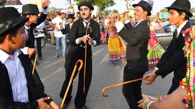 Mavani (C) breaks into a jig with other impersonators. He was four when he started acting and has been celebrating Chaplin’s birthday ever since then with his grandfather. And he looks to follow in his grandfather’s footsteps by succeeding Aswani as president of the Charlie Circle. (Indranil Mukherjee / AFP) Mavani (C) breaks into a jig with other impersonators. He was four when he started acting and has been celebrating Chaplin’s birthday ever since then with his grandfather. And he looks to follow in his grandfather’s footsteps by succeeding Aswani as president of the Charlie Circle. (Indranil Mukherjee / AFP)