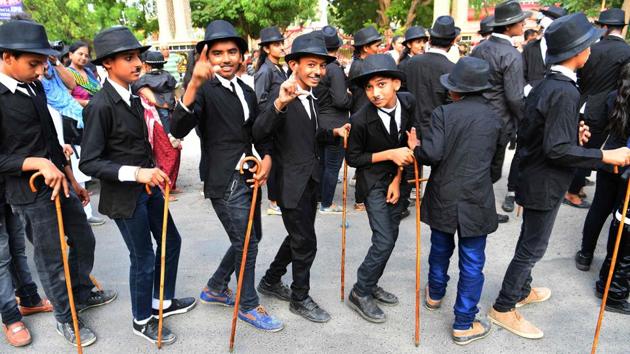 Young Charlie Chaplin impersonators pose for a picture during the event. On Monday, Aswani was joined by roughly 300 others, a solid turnout for an event that started with one man. Children wore Chaplin face masks while some carried life-sized cut-outs of the English-born filmmaker as a stereo loaded onto a truck belted popular Bollywood songs. (Indranil Mukherjee / AFP) Young Charlie Chaplin impersonators pose for a picture during the event. On Monday, Aswani was joined by roughly 300 others, a solid turnout for an event that started with one man. Children wore Chaplin face masks while some carried life-sized cut-outs of the English-born filmmaker as a stereo loaded onto a truck belted popular Bollywood songs. (Indranil Mukherjee / AFP)