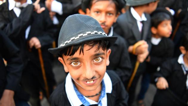 Wearing bowler hats and fake moustaches while carrying walking sticks, hundreds of Charlie Chaplin fans shuffled bow-legged through Adipur in Gujarat to celebrate the comic actor’s 129th birthday this week. Every year on April 16, residents of Adipur honour the legendary silent actor’s birthday by imitating his slapstick style in a parade. (Indranil Mukherjee / AFP) Wearing bowler hats and fake moustaches while carrying walking sticks, hundreds of Charlie Chaplin fans shuffled bow-legged through Adipur in Gujarat to celebrate the comic actor’s 129th birthday this week. Every year on April 16, residents of Adipur honour the legendary silent actor’s birthday by imitating his slapstick style in a parade. (Indranil Mukherjee / AFP)