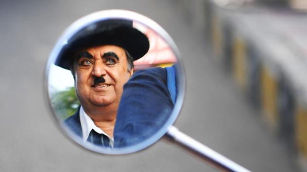 Ashok Aswani, founder of the Charlie Circle fan club, is reflected in a mirror as his daughter Monica drives him around. He was cycling to work one day in the early ‘70s when he passed a theatre showing Chaplin’s 1925 hit “The Gold Rush”. He bought a ticket and went in. Immediately hooked, Aswani watched three consecutive shows, skipping work. He was fired from his job the next day. (Indranil Mukherjee / AFP) Ashok Aswani, founder of the Charlie Circle fan club, is reflected in a mirror as his daughter Monica drives him around. He was cycling to work one day in the early ‘70s when he passed a theatre showing Chaplin’s 1925 hit “The Gold Rush”. He bought a ticket and went in. Immediately hooked, Aswani watched three consecutive shows, skipping work. He was fired from his job the next day. (Indranil Mukherjee / AFP)