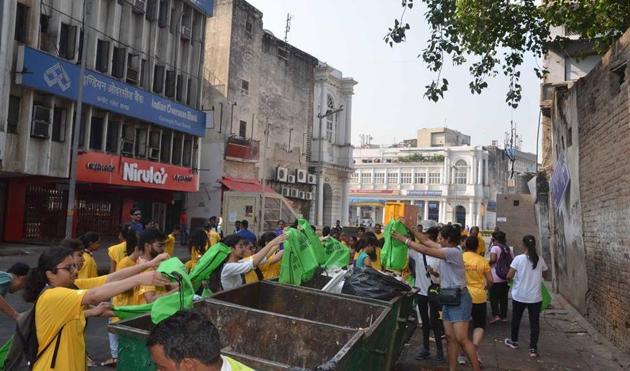 Participants of Run to Clean use biodegradable bags to collect and dispose garbage in bins, during one of their events in Connaught Place, last year.