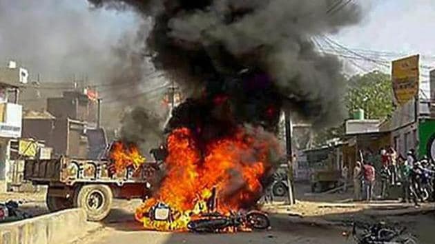 Smoke billows from a burning bus during 'Bharat Bandh' call by Dalit organisations against the alleged dilution of Scheduled Castes/Scheduled Tribes Act, in Alwar on April 2. (PTI File Photo) Smoke billows from a burning bus during 'Bharat Bandh' call by Dalit organisations against the alleged dilution of Scheduled Castes/Scheduled Tribes Act, in Alwar on April 2. (PTI File Photo)