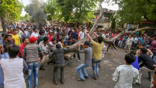 Members of the Dalit community block a road as they protest against the alleged ‘dilution’ of SC/ST Act, in Ahmedabad. The Centre has moved the SC seeking a review of its order. (PTI File Photo) Members of the Dalit community block a road as they protest against the alleged ‘dilution’ of SC/ST Act, in Ahmedabad. The Centre has moved the SC seeking a review of its order. (PTI File Photo)