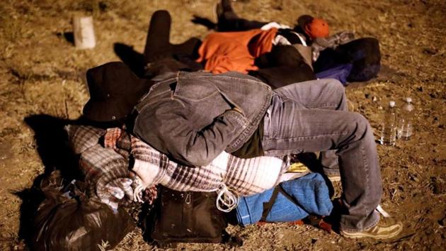 A Central American migrant, moving in a caravan through Mexico, sleeps on his belongings next to a railway line, in Tlaquepaque, in Jalisco state, Mexico. A group of 50 migrants who set out from southern Mexico in late March have reached the U.S. border, having endured the long journey despite threats by President Donald Trump to secure the border with National Guard personnel whereas others believed to arrive in upcoming days. (Edgard Garrido / REUTERS) A Central American migrant, moving in a caravan through Mexico, sleeps on his belongings next to a railway line, in Tlaquepaque, in Jalisco state, Mexico. A group of 50 migrants who set out from southern Mexico in late March have reached the U.S. border, having endured the long journey despite threats by President Donald Trump to secure the border with National Guard personnel whereas others believed to arrive in upcoming days. (Edgard Garrido / REUTERS)