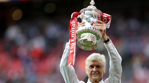 FILE PHOTO: Arsenal FC manager Arsene Wenger celebrates with the FA Cup after beating Chelsea FC in the final last season.(Action Images via Reuters)