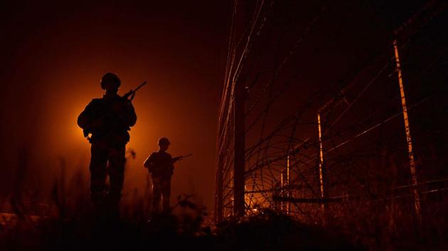 In this file photo taken on January 11, 2013, Indian Border Security Force (BSF) soldiers patrol along the border fence at an outpost along the India-Pakistan border in Suchit-Garh some 36 kms southwest of Jammu.(AFP)