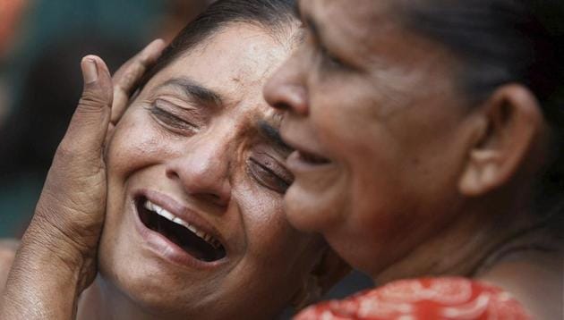 Relatives of those convicted in the Naroda Patiya riots case break down outside the court on the day of pronouncement of sentence in the case, in Ahmedabad in August 2012.(PTI File Photo)