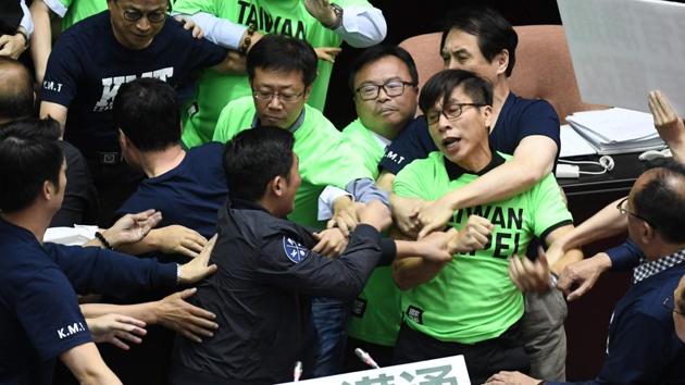 Lawmakers from the ruling Democratic Progressive Party (DPP) and the Kuomintang (KMT) scuffle during a protest at the Parliament in Taipei on April 20, 2018.(AFP) Lawmakers from the ruling Democratic Progressive Party (DPP) and the Kuomintang (KMT) scuffle during a protest at the Parliament in Taipei on April 20, 2018.(AFP)