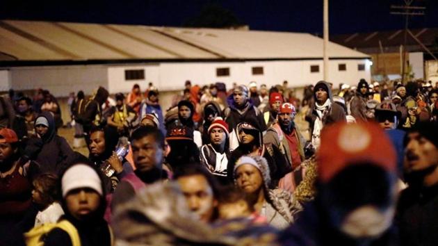 A carvan of Central American migrants wait next to a railway line. Honduras, El Salvador and Guatemala are among the most violent and impoverished countries in the Americas, prompting many people to leave in search of a better life. (Edgard Garrido / REUTERS) A carvan of Central American migrants wait next to a railway line. Honduras, El Salvador and Guatemala are among the most violent and impoverished countries in the Americas, prompting many people to leave in search of a better life. (Edgard Garrido / REUTERS)