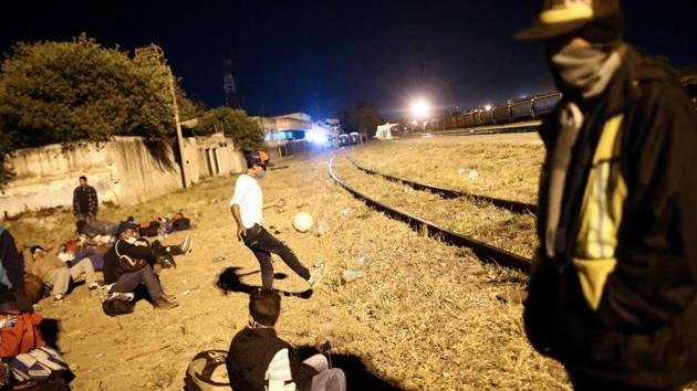 A boy plays with a ball next to a railway line before embarking on a new leg of his travel. The carvan was to have formally ended in Mexico City, but many of the migrants feared going solo on the dangerous final leg north and decided to keep travelling en masse. Some who had split off to press on alone reported back about kidnappings and having their papers for safe passage torn up. (Edgard Garrido / REUTERS) A boy plays with a ball next to a railway line before embarking on a new leg of his travel. The carvan was to have formally ended in Mexico City, but many of the migrants feared going solo on the dangerous final leg north and decided to keep travelling en masse. Some who had split off to press on alone reported back about kidnappings and having their papers for safe passage torn up. (Edgard Garrido / REUTERS)