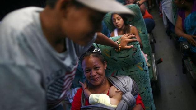 A woman carrying her child smiles while moving in a carvan. Mexico’s National Immigration Institute said its agents found a total of 191 mostly Central American migrants jammed into a truck and a bus in southern and central Mexico on April 19, 2018. (Edgard Garrido / REUTERS) A woman carrying her child smiles while moving in a carvan. Mexico’s National Immigration Institute said its agents found a total of 191 mostly Central American migrants jammed into a truck and a bus in southern and central Mexico on April 19, 2018. (Edgard Garrido / REUTERS)