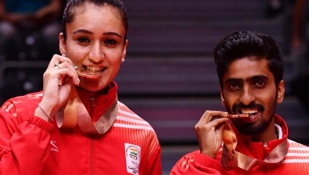 G Sathiyan Gnanasekara and Manika Batra (L) pose during the medal ceremony for the mixed doubles table tennis event at the 2018 2018 Commonwealth Games (CWG 2018) in Gold Coast on April 15. Along with the bronze in the mixed doubles, Sathiyan won a silver in the men’s doubles partnering Achanta Sharath Kamal, and gold in the men’s team event.(AFP)