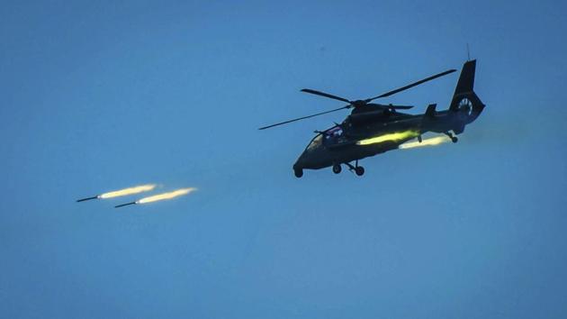 In this photo provided by China's Xinhua News Agency, a Chinese armed helicopter assaults targets with rocket projectiles in a live-fire exercise off China's southeast coast.(AP File Photo)
