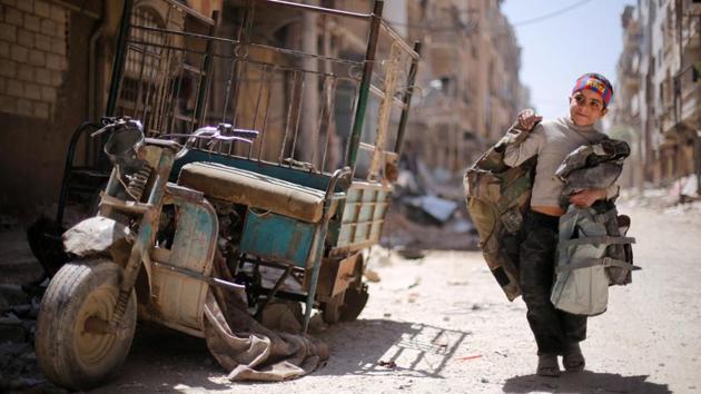 A boy walks along a damaged street at the city of Douma in Damascus, Syria on April 16, 2018. (Omar Sandiki / REUTERS)