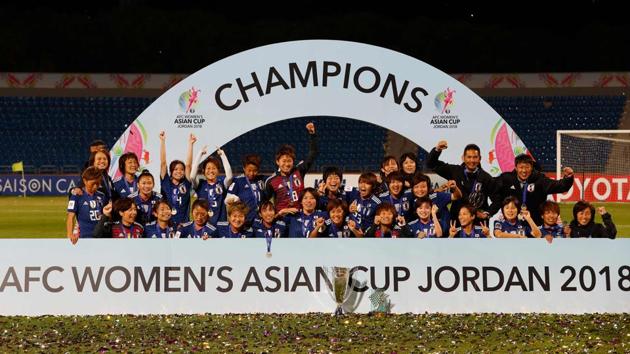 Japan's players celebrate with the trophy after winning the AFC Women's Asian Cup final against Australia at the King Abdullah II Stadium in the Jordanian capital Amman on Friday.(AFP)