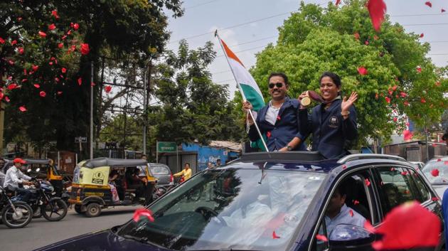 Shooter Tejaswini Sawant who won Gold and Silver medals in 50m rifle 3 positions and 50m rifle prone shooting events at Gold Coast Commonwealth games and her husband wave to a crowd in Kothrud, Pune on April 15, 2018. (Sanket Wankhade / HT Photo) Shooter Tejaswini Sawant who won Gold and Silver medals in 50m rifle 3 positions and 50m rifle prone shooting events at Gold Coast Commonwealth games and her husband wave to a crowd in Kothrud, Pune on April 15, 2018. (Sanket Wankhade / HT Photo)