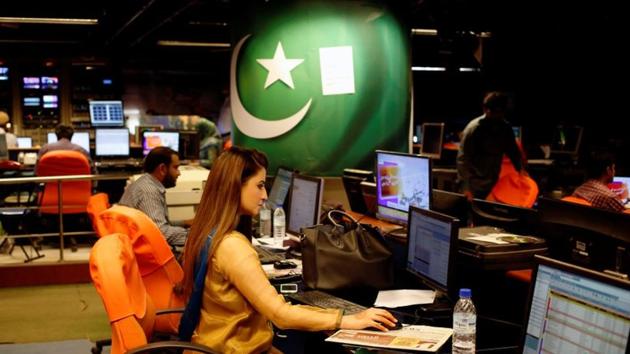 An employee works at the control room of the Geo News television channel in Karachi.(REUTERS)