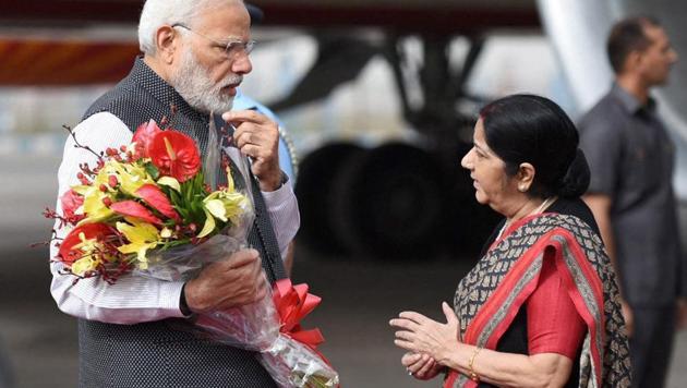 Prime Minister Narendra Modi being greeted by the external affairs minister Sushma Swaraj on his return to India after a three-nation tour, in New Delhi on Saturday. Swaraj left for China to participate in the SCO meet. (PTI) Prime Minister Narendra Modi being greeted by the external affairs minister Sushma Swaraj on his return to India after a three-nation tour, in New Delhi on Saturday. Swaraj left for China to participate in the SCO meet. (PTI)
