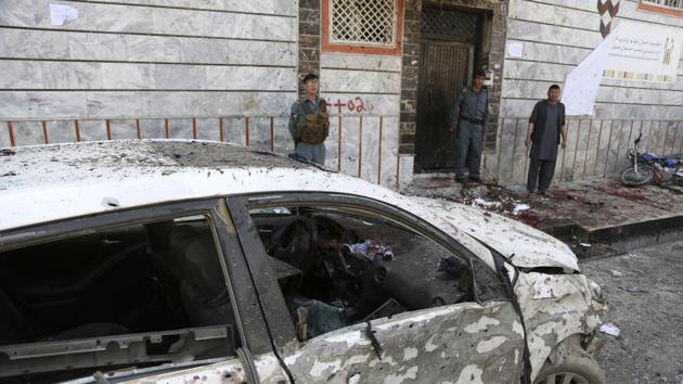 Afghan police stand outside a voter registration centre which was attacked by a suicide bomber in Kabul, Afghanistan.(AP Photo) Afghan police stand outside a voter registration centre which was attacked by a suicide bomber in Kabul, Afghanistan.(AP Photo)