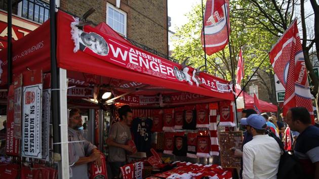 Vendors sell merchandise featuring Arsene Wenger ahead of the Premier League match against West Ham. (AFP) Vendors sell merchandise featuring Arsene Wenger ahead of the Premier League match against West Ham. (AFP)
