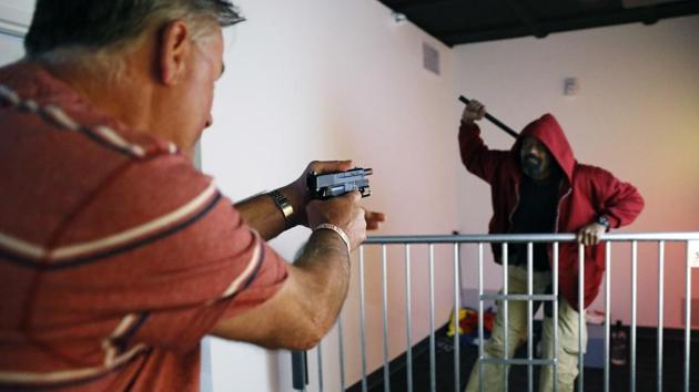 A visitor, Tom Coull, reacts as training officer Russell Harris acts out a scenario at the Use of Force Training Experience in the Mob Museum in Las Vegas. (AP) A visitor, Tom Coull, reacts as training officer Russell Harris acts out a scenario at the Use of Force Training Experience in the Mob Museum in Las Vegas. (AP)