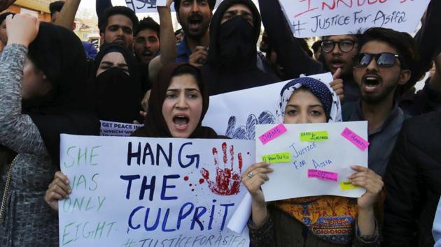 A woman holds a placard as she takes part in a protest demanding justice in the rape and murder case of eight-year-old girl in Jammu’s Kathua district, in Srinagar, on April 14.(Waseem AndrabiHT file photo)