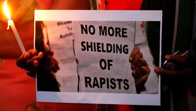 People participate in a candle light vigil as they protest against the rape of an eight-year-old girl in Kathua near Jammu, and a teenager in Uttar Pradesh’s Unnao, in Ahmedabad.(REUTERS)