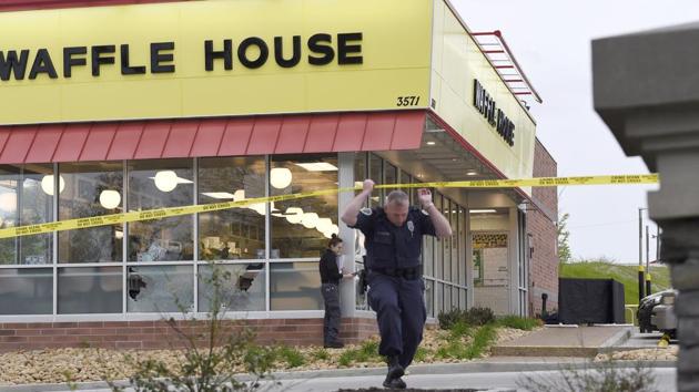 Law enforcement officials work the scene of a fatal shooting at a Waffle House in the Antioch neighbourhood of Nashville, on April 22, 2018. The shooter fled from the spot after losing his gun. (The Tennessean via AP) Law enforcement officials work the scene of a fatal shooting at a Waffle House in the Antioch neighbourhood of Nashville, on April 22, 2018. The shooter fled from the spot after losing his gun. (The Tennessean via AP)