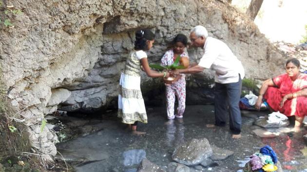 The spring at Bavdhan, a natural one , was at the centre of a puja being performed on Sunday by residents seeking blessings for their efforts to clean the water fount and to persuade the municipal officials to preserve this “heritage site” from the ongoing march of urbanisation.(HT PHOTO)