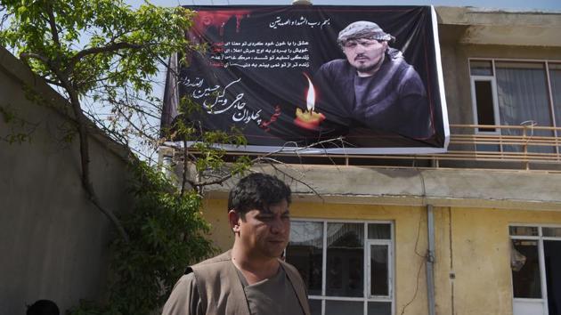 Ghulam Sakhi Allahdad looks on as he stands under a poster with the image of his brother Wakil Hussain Allahdad, one of the 57 victims of a bomb blast. Whenever suicide attackers struck his fellow Shiites in Kabul, Wakil would rush to the scene to help. (Wakil Koshar/ AFP) Ghulam Sakhi Allahdad looks on as he stands under a poster with the image of his brother Wakil Hussain Allahdad, one of the 57 victims of a bomb blast. Whenever suicide attackers struck his fellow Shiites in Kabul, Wakil would rush to the scene to help. (Wakil Koshar/ AFP)