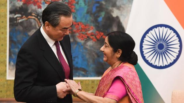 External affairs minister Sushma Swaraj shakes hands with China's foreign minister Wang Yi at the Diaoyutai State Guest House in Beijing on Sunday.(AFP Photo)